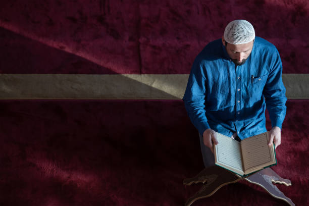 istock muslim man praying Allah alone inside the mosque and reading islamic holly book 1311357737