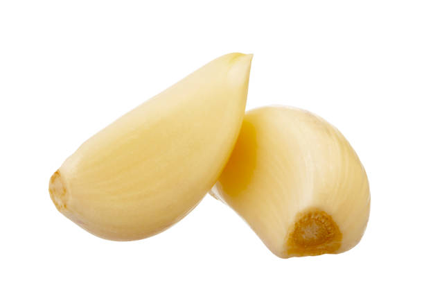 garlic cloves isolated on white background peeled garlic cloves isolated on white background acrid taste stock pictures, royalty-free photos & images