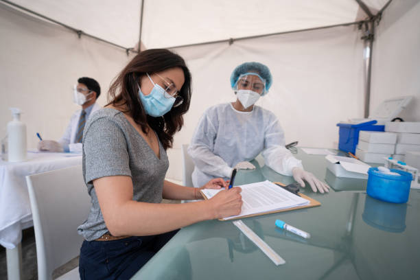 istock Woman signing a consent while getting a PCR COVID-19 test 1311358594