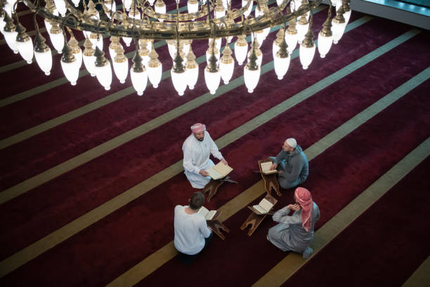 istock muslim people in mosque reading quran together 1311359589