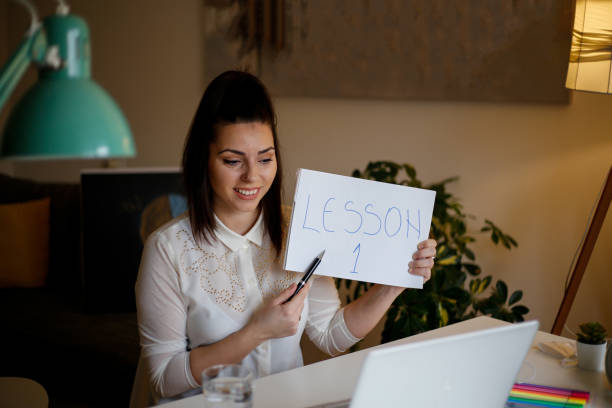 istock Professor using computer and teaching her students online from home. stock photo 1311360485