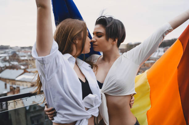 istock Lesbians hug and love each other with LGBT flag 1311361191