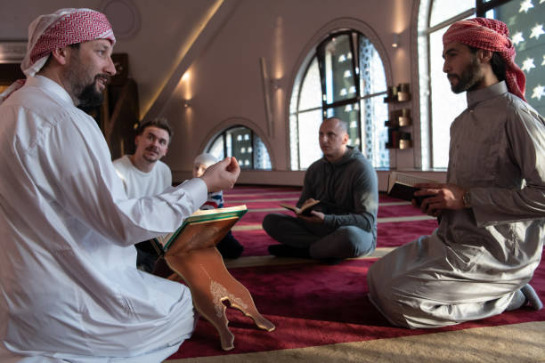 istock muslim people in mosque reading quran together 1311362803