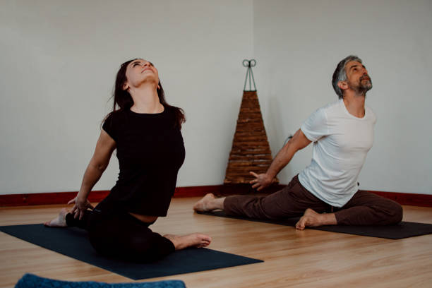 istock Couple doing yoga at home 1311367017