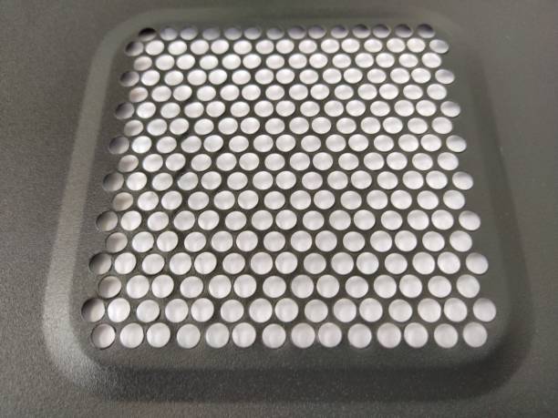 istock ventilation mesh of the computer. Metal surface with round numerous holes 1311367024