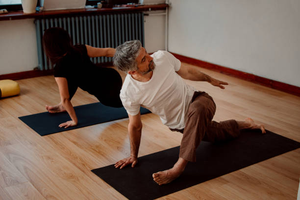 istock Couple doing yoga at home 1311367640