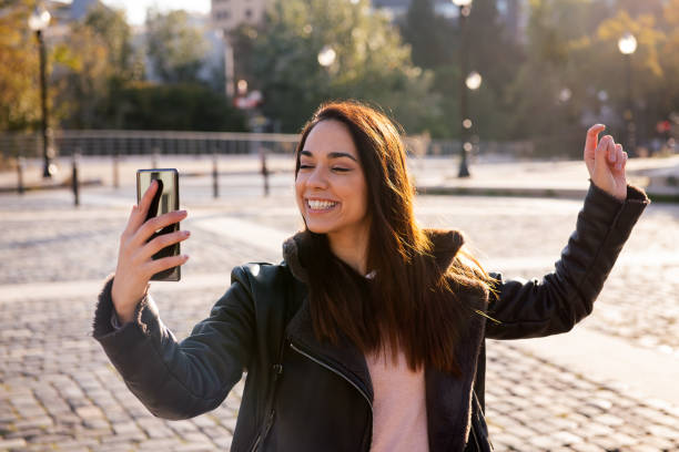 istock happy woman celebrating looking the phone 1311367683