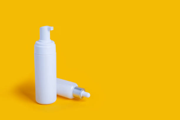 istock cosmetic bottles on yellow background with copy space 1311370186