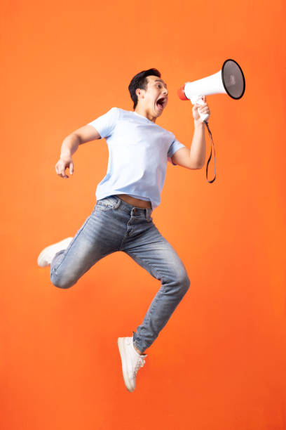 the man is holding a speaker - filipino ethnicity audio imagens e fotografias de stock