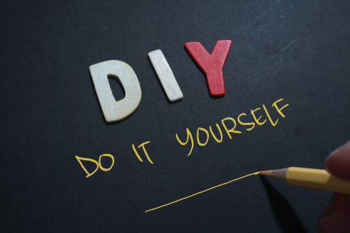 DIY do it yourself, text words typography written on wooden lettering, life and business motivational inspirational concept