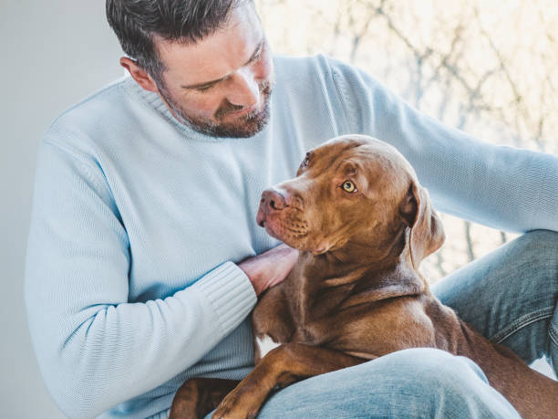 istock Handsome man and a charming puppy. Closeup 1311382306