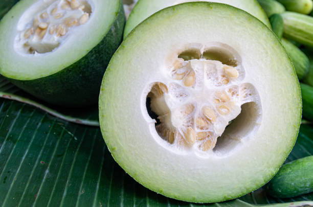 close up of a cut winter melon (Wax gourd) close up of a cut winter melon (Wax gourd) - background blur waxed gourds stock pictures, royalty-free photos & images