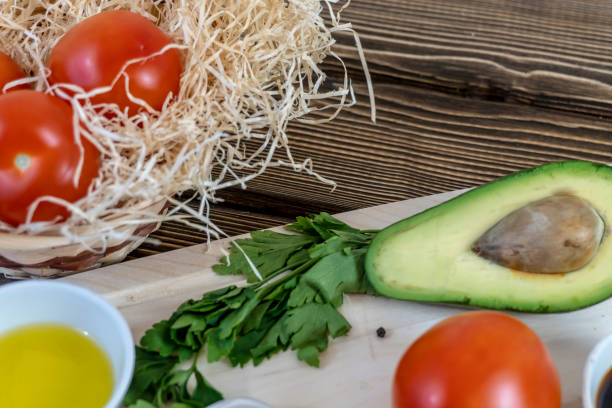 istock Tomatoes, cucumbers and avocado on the table, olive oil and balsamic vinegar, garlic, vegetables, vegetarianism, healthy eating 1311382593