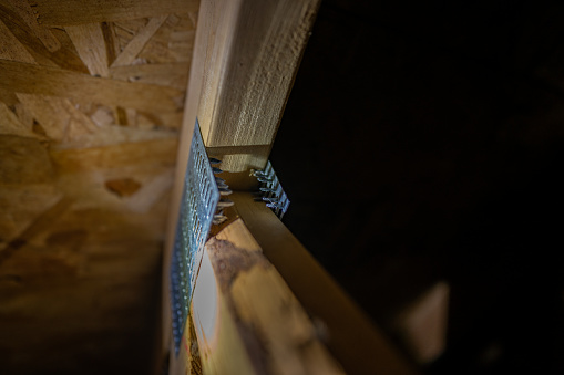 Connecting galvanized mending nail plate on a attic rafter