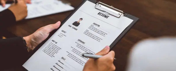 Photo of Businesswoman submits resume employer to review job application information on the desk, presents the ability for the company to agree with the position of the job.