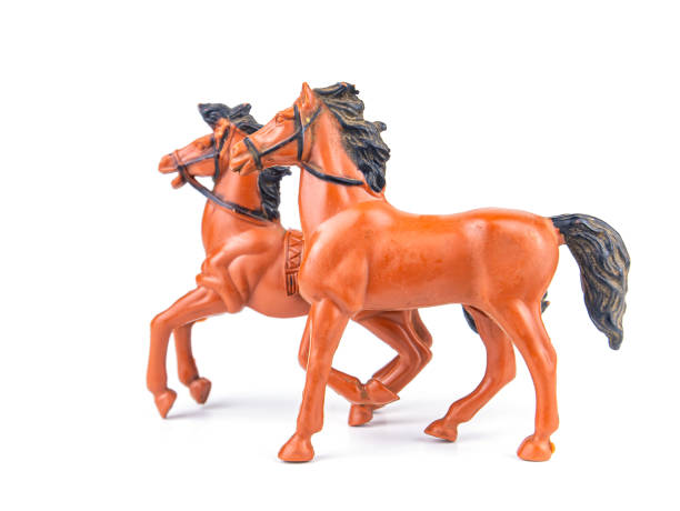 A pair of brown horses with black mane on a white background. Horse pair. Pets. Livestock farm. Horse and mare. Childrens toys animals. White background. Background image.
