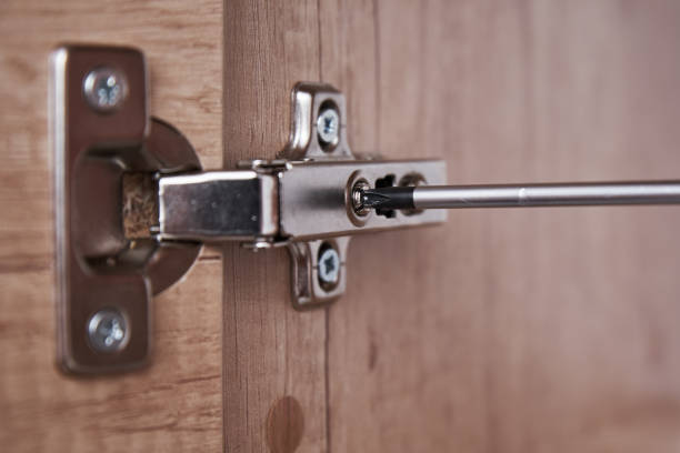 istock Hand screwing door hinge on kitchen cabinet 1311389234