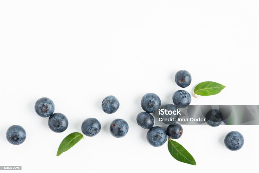 Fresh blueberries background top view. Fresh blueberries background top view. White background with blueberry berries. Summertime. Bilberry - Fruit Stock Photo