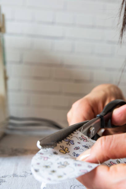 istock housewife is cutting fabric with serrated scissors 1311395046