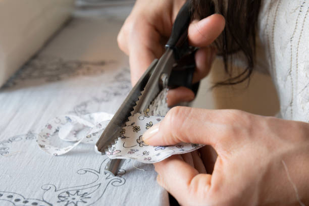 istock housewife is cutting fabric with serrated scissors 1311395070