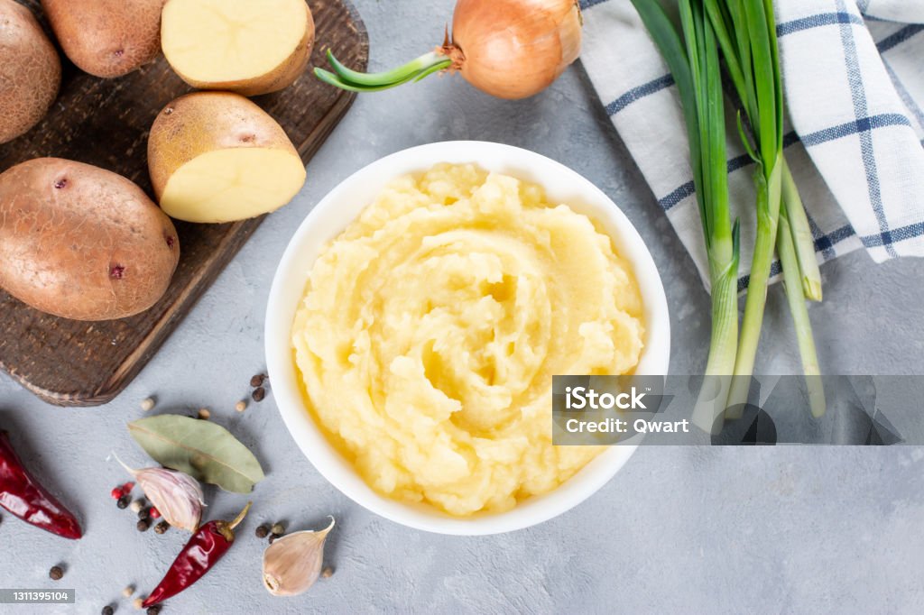 Mashed potatoes in bowl on a gray background. Top view with copy space Mashed potatoes in bowl on a light gray background. Top view with copy space Mashed Potatoes Stock Photo