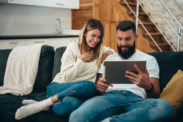 istock Couple using tablet for video call at home 1311396002