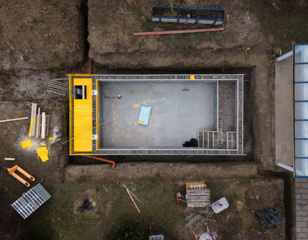 istock Drone shot of construction site from pool with formwork for concrete and finished brick wall 1311396006