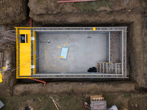 istock Drone shot of construction site from pool with formwork for concrete and finished brick wall 1311396007