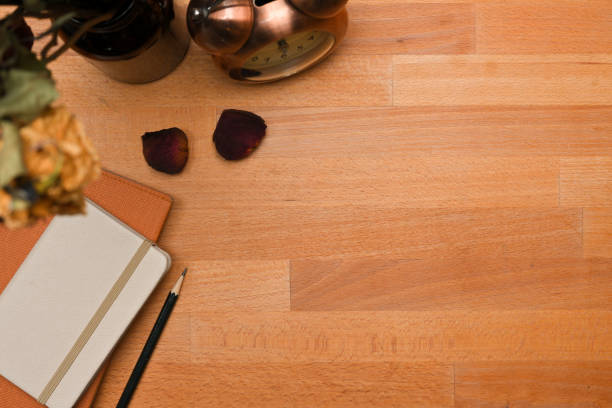 istock Creative flat lay workspace with books, pen, alarm clock, flower vase and copy space 1311396282