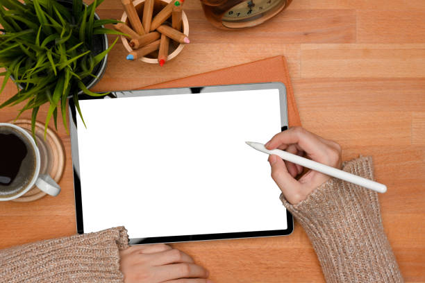 istock Female hands with stylus pen using digital tablet include clipping path screen on wooden table 1311396290