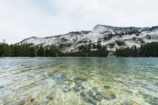 Clean transparent glacier lake at Yosemite National Park seen a cloudy day in summer.