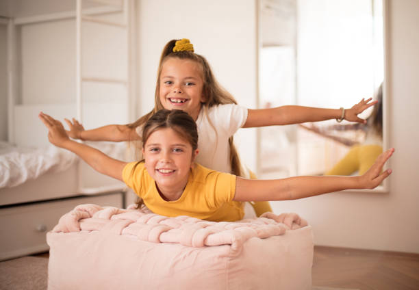 istock Sisters playing together in bedroom. 1311397530
