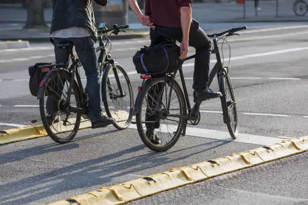cyclist waiting on protected bike lane