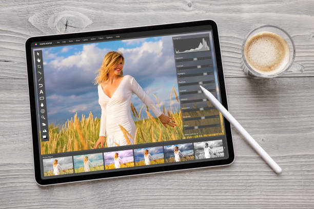 Concept of digital photo editing on tablet computer with wireless stylus pen Concept photo from above of digital photo editing on tablet computer with wireless stylus pen mobile app photos stock pictures, royalty-free photos & images
