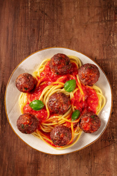 istock Meatballs with spaghetti, tomato sauce, and basil, overhead shot 1311401266