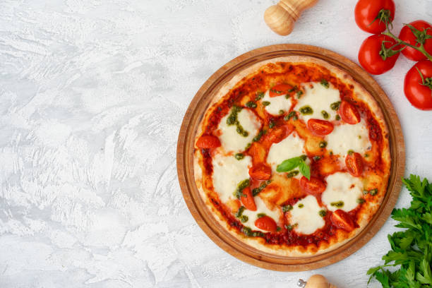 istock Top view of pizza Margherita on gray surface 1311403732
