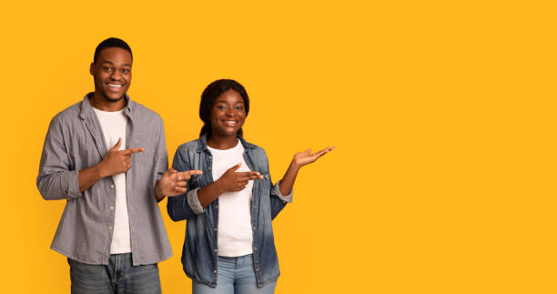 istock Check This. Happy Smiling Black Couple Pointing Aside At Copy Space 1311405093