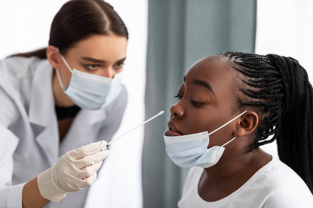 istock Doctor taking PCR test sample from potentially infected black patient 1311406296