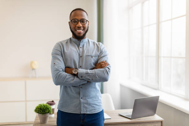 istock Successful African American Businessman Posing Standing In Modern Office 1311407557