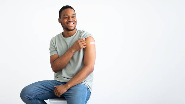 istock African Man Showing Vaccinated Arm With Medical Plaster, White Background 1311409826