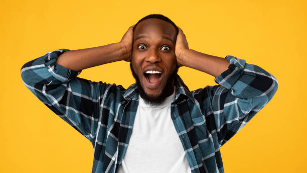 istock Shocked African American Man Shouting Omg Touching Head, Yellow Background 1311410654