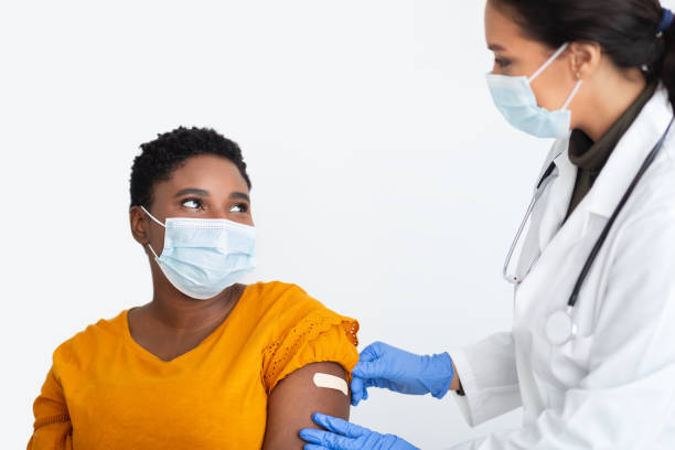 istock Doctor Sticking Plaster On Arm After Coronavirus Vaccination, White Background 1311410702
