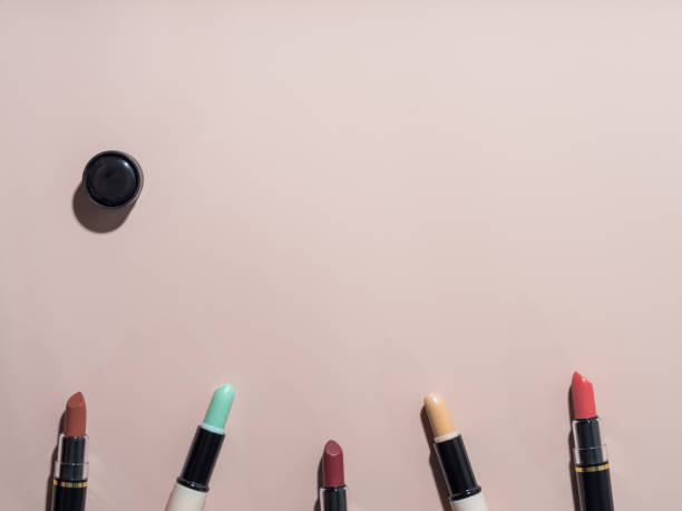 istock Top view: open lipsticks and face concealers. Make-up products. Powdery background 1311412686
