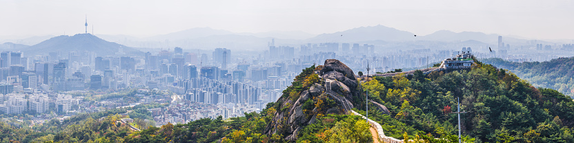 The city walls on top of Inwangsan mountain peak looking out over the crowded cityscape of Seoul, South Korea’s vibrant capital city.