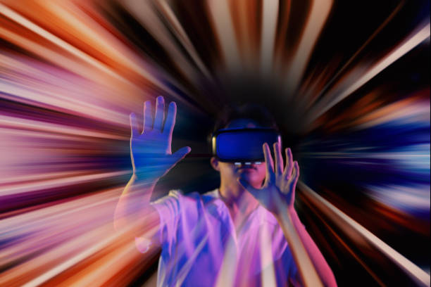 istock Excited young Asian man getting experience with VR virtual reality headset or 3D glasses and having fun, double exposure. interacts with a virtual screen. concept of the future 1311413685