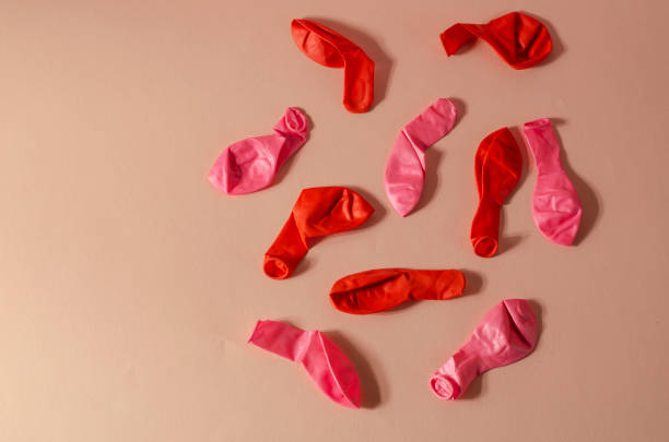 istock Minimalistic composition with deflated balloons on a pink backgr 1311413760