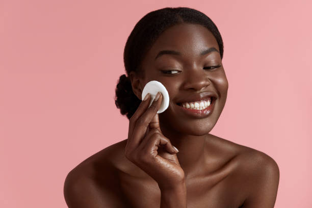 istock Black girl touch her face with cotton pad 1311418545