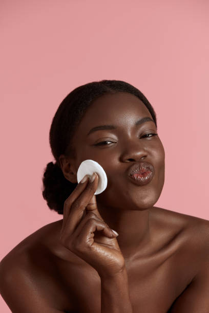 istock Black girl touch her face with cotton pad 1311418604