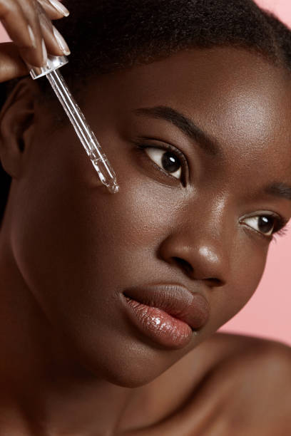 Girl dropping serum collagen moisturizer on face