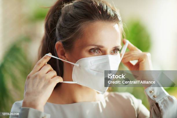 Woman In Grey Blouse Wearing Ffp2 Mask Stock Photo - Download Image Now - Protective Face Mask, FFP2 Mask, Coronavirus